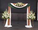 Three simple white flower arrangements to make your wedding ceremony special. Add a wooden arch and two gold risers to elevate these three simple pieces to the next level, and Voilà. You now have the perfect setting for your wedding day. 